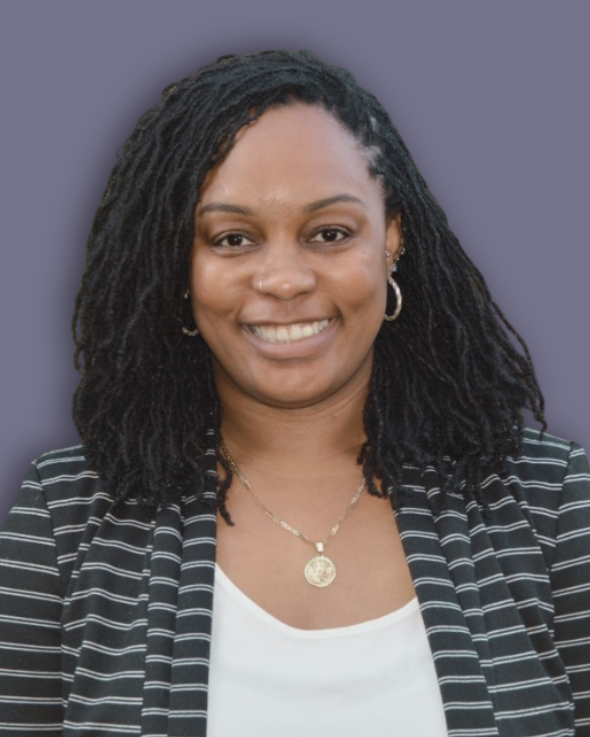 Charlene Grant's headshot against a dark lilac background. Charlene is smiling in the photo and wears a black and white blazer and white vest.