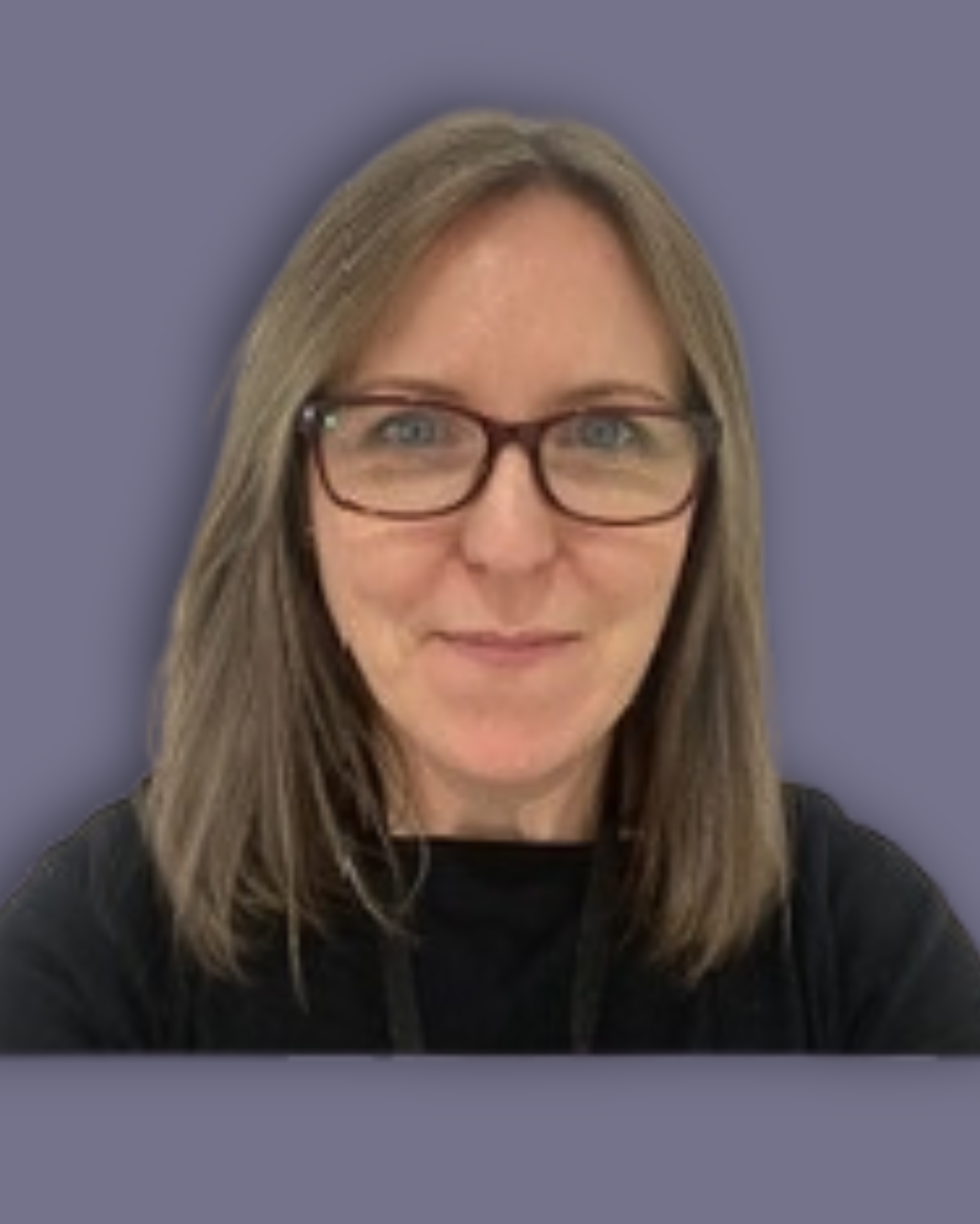 A headshot of Longleigh Trustee, Fiona Smith, who has shoulder-length brown hair, is wearing glasses and a black top, standing against a plain white background. She is looking directly at the camera with a slight smile.