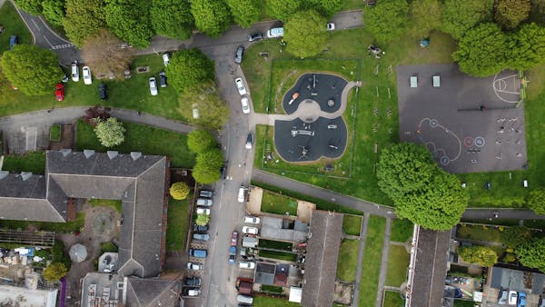 Aerial view of rural community, featuring green space and playgrounds.