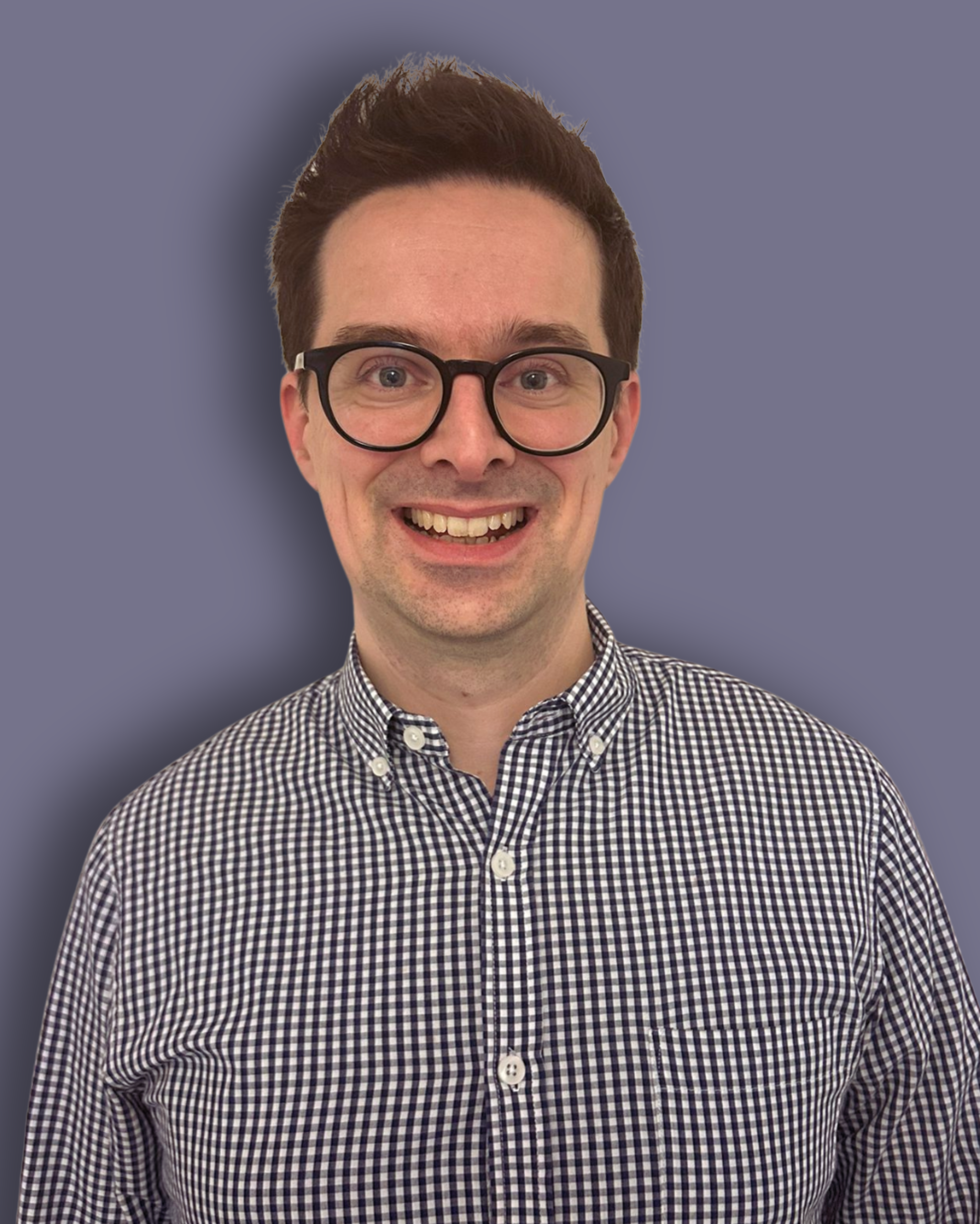 A headshot photo with a purple background of James Holton, a Trustee at Longleigh Foundation. James is wearing a white and black checkered shirt. James has short brown hair and has a bright smile.